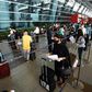 At New Delhi airport, hundreds of people anxious to get home but apprehensive about the risks queued from before dawn