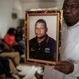A spokesperson for bereaved relatives holds a portrait of Anastacio Matavele, an election monitor who was gunned down ahead of a key vote last October