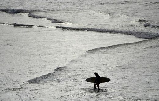 Surfers rushed to Sydney's famous Bondi beach as Australia took its first steps in easing coronavirus restrictions