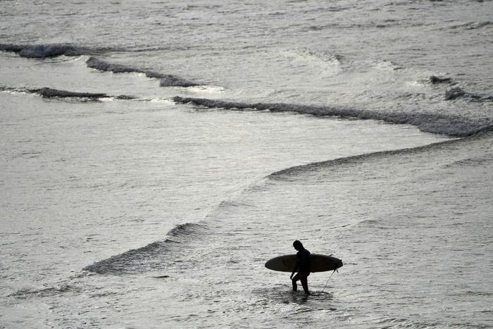 Surfers rushed to Sydney's famous Bondi beach as Australia took its first steps in easing coronavirus restrictions