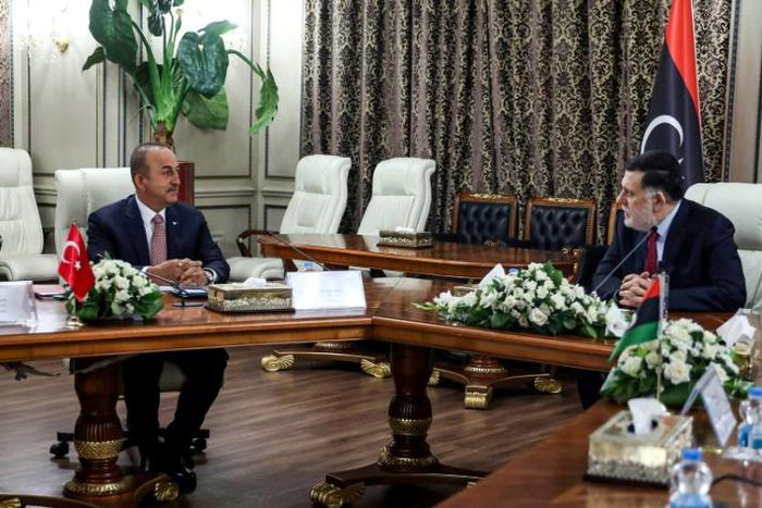 The head of Libya's UN-recognised Government of National Accord, Fayez al-Sarraj (R), met with top Turkish diplomat Mevlut Cavusoglu at the GNA headquarters in the capital Tripoli