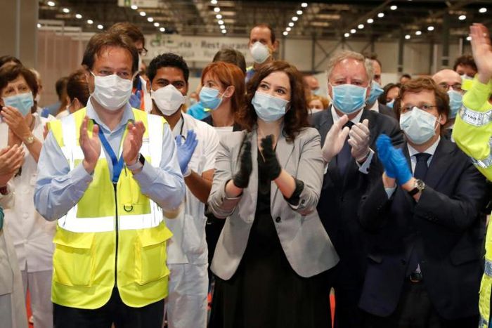 Madrid regional president Isabel Diaz Ayuso and Mayor Jose-Luis Martinez Almeida applaud as the field hospital is closed -- but social media users questioned such a large gathering and an apparent lack of social distancing