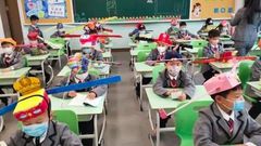 Pupils wear social distancing headgears to class