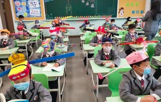 Pupils wear social distancing headgears to class