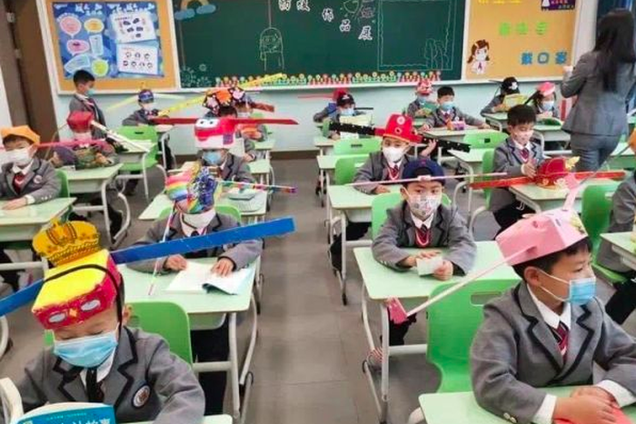 Pupils wear social distancing headgears to class