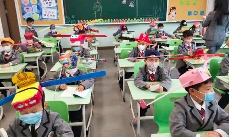 Pupils wear social distancing headgears to class