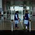 Staff clean the arrivals terminal at Cochin International Airport in Kochi ahead of the arrival of a first repatriation flight carrying Indian citizens from the Gulf
