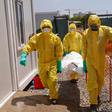 Members of International Medical Corps (IMC) carry the body of a COVID-19 victim at a Ministry of Health Infectious Disease Unit in Juba, South Sudan