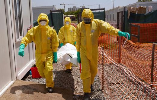 Members of International Medical Corps (IMC) carry the body of a COVID-19 victim at a Ministry of Health Infectious Disease Unit in Juba, South Sudan