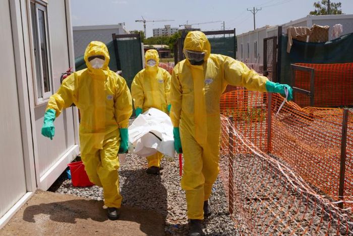 Members of International Medical Corps (IMC) carry the body of a COVID-19 victim at a Ministry of Health Infectious Disease Unit in Juba, South Sudan