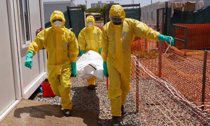 Members of International Medical Corps (IMC) carry the body of a COVID-19 victim at a Ministry of Health Infectious Disease Unit in Juba, South Sudan