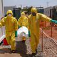 Members of International Medical Corps (IMC) carry the body of a COVID-19 victim at a Ministry of Health Infectious Disease Unit in Juba, South Sudan