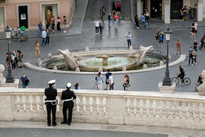 Police keep watch near the Spanish Steps at Piazza di Spagna, in Rome, as the city takes cautious steps to end the virus lockdown