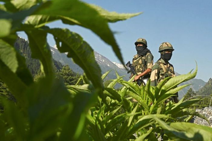 Indian Border Security Force soldiers guard a highway leading towards China, in Gagangir on June 17