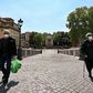 People wearing face masks carry their groceries across the Ponte Sisto bridge on April 24, 2020 in Rome, during the country's lockdown aimed at stopping the spread of the COVID-19 pandemic, caused by the novel coronavirus