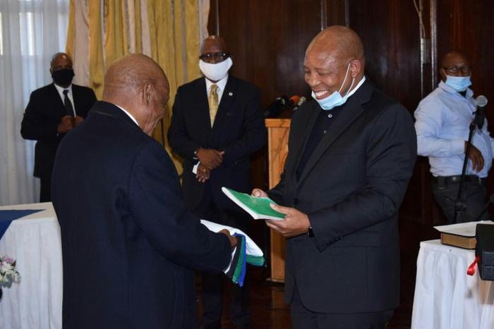 Lesotho's former prime minister Thomas Thabane (L) said he "may have inadvertently erred" during his term, as he handed power to Moeketsi Majoro