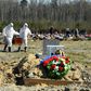 Cemetery workers in protective gear bury a coronavirus victim at a cemetery on the outskirts of Saint Petersburg. Russia has reported a remarkably low death toll but critics have cast doubt on the numbers