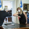 President Sebastian Pinera greets his new Minister for Women Macarena Santelices with an elbow bump at the presidential palace in Santiago, Chile