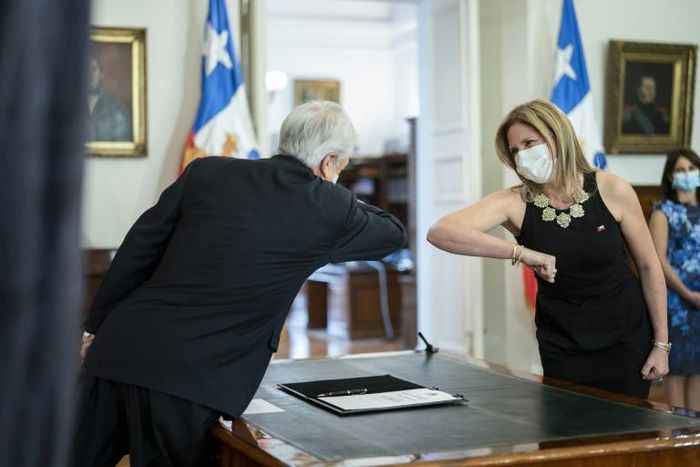 President Sebastian Pinera greets his new Minister for Women Macarena Santelices with an elbow bump at the presidential palace in Santiago, Chile