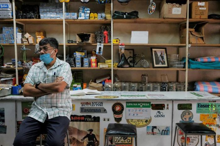 In a store that sells bicycle spare parts, the Shah brothers are feeling the impact of the pandemic on the economy