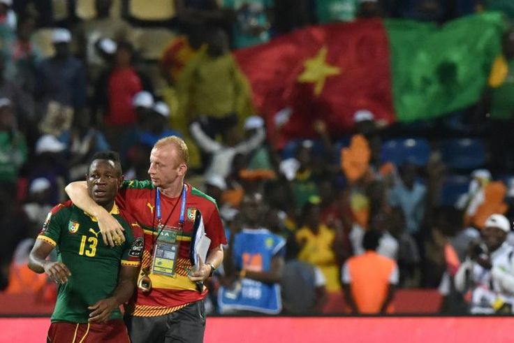 Midfielder Christian Bassogog (L) and assistant coach Sven Vandenbroeck celebrate after Cameroon won the 2017 Africa Cup of Nations final against Egypt in Libreville