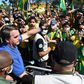 Brazilian President Jair Bolsonaro (C) has opposed lockdown measures