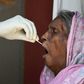 A woman is tested for coronavirus in New Delhi. Cases are soaring in the world's second most populous nation