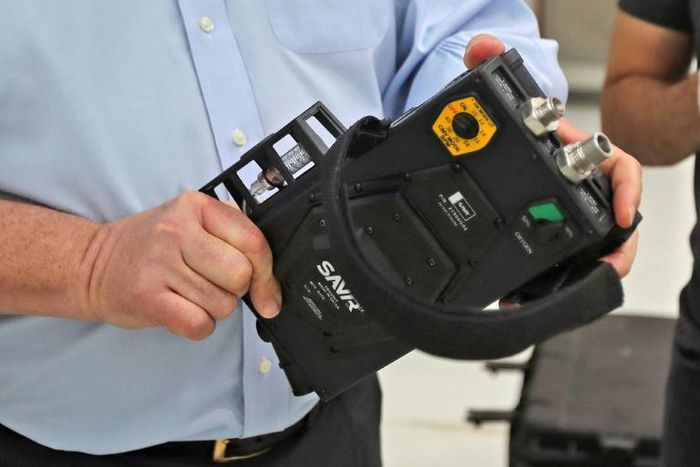 James W. Teetzel, CEO and founder of American defence manufacturer Wilcox, holds a medical ventilator at Qatar's Barzan facility, in the capital Doha