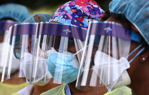 FILE - In this May 4, 2020, file photo, volunteers line up to begin taking hundreds of free COVID-19 tests at a pop-up site at the House of Hope in Decatur, Ga. Many African Americans watching protests calling for easing restrictions meant to slow the ...