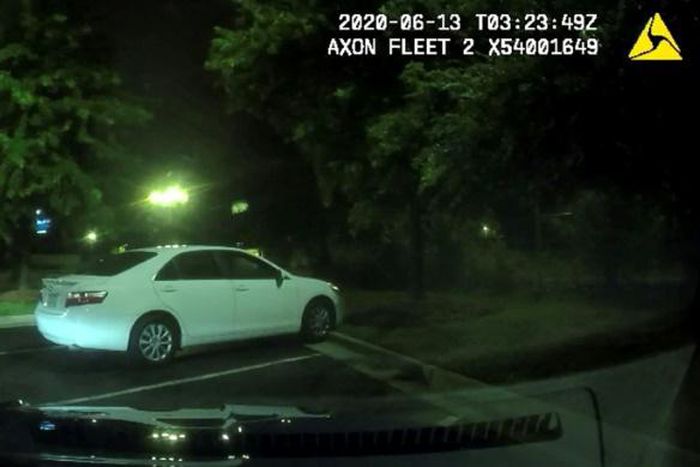 This undated handout photo obtained June 14, 2020, from the Atlanta (Georgia) Police Department shows an image from a video camera of a struggle a day earlier between police officers and suspect Rayshard Brooks (L)