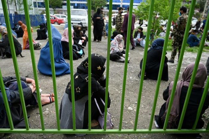 Afghan women keep their distance from each other while waiting for a bread handout in the capital, Kabul