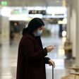 Wearing a mask and gloves in a terminal of Franz-Josef-Strauss Airport in Munich