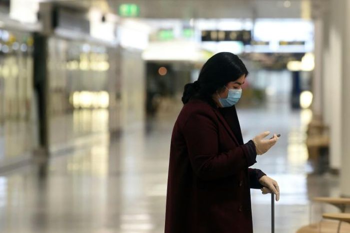 Wearing a mask and gloves in a terminal of Franz-Josef-Strauss Airport in Munich