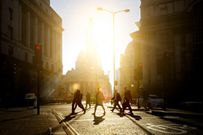 Walking to work through the city at sunrise