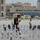 A masked man checks his phone in Qatar where residents and citizens have been required by law to install a coronavirus contact tracing app on their handsets since Friday