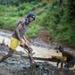 A group mines gold from a riverbed southwest of the city of Bukavu, in the DR Congo in March 2017