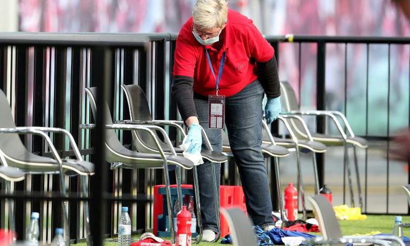 A member of staff cleans the substitute bench during half time of RB Leipzig's draw with Hertha Berlin