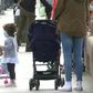 Children in Madrid enjoy the sunshine with their parents, as they are allowed outside on Sunday for the first time in six weeks