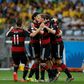 Germany players celebrate after Thomas Mueller opens the scoring against Brazil as a forlorn David Luiz looks on disconsolately