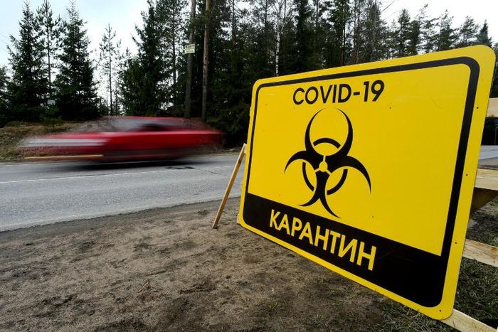 A sign reads "Quarantine COVID-19" outside the village of Pervomaiskoye near Saint Petersburg
