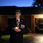 Veteran Peter McFarlane holds a candle during an Anzac Day dawn vigil outside his house in suburbs of Sydney