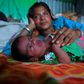 Manju Bauri rests with her newborn baby boy 'Lockdown' in their temporary home in northeast India