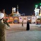 A cleric prays outside the Fatima Masumeh shrine in Iran's holy city of Qom on March 16, 2020, the day it was closed due to the coronavirus