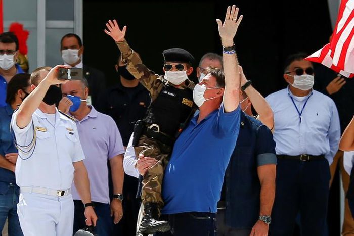 Brazil's President Jair Bolsonaro, pictured (center, in blue) on May 17 2020, shares his US counterpart's tendency to disregard scientific evidence that contradicts him