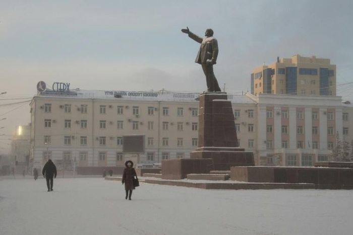Locals walk through a square in the Siberian city of Yakutsk, where a court ruled to commit a shaman critical of Vladimir Putin to a mental asylum