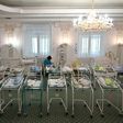 A nurse cares for newborn babies at Kiev's Venice hotel -- dozens born to surrogate mothers were stranded in Ukraine as their foreign parents were unable to collect them for weeks owing to coronavirus border closures