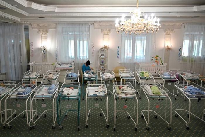 A nurse cares for newborn babies at Kiev's Venice hotel -- dozens born to surrogate mothers were stranded in Ukraine as their foreign parents were unable to collect them for weeks owing to coronavirus border closures