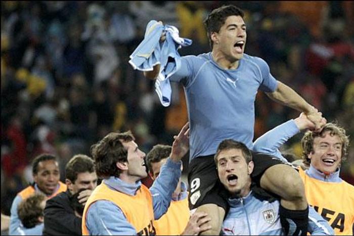 Suarez being hailed by his Uruguay teammates after the game