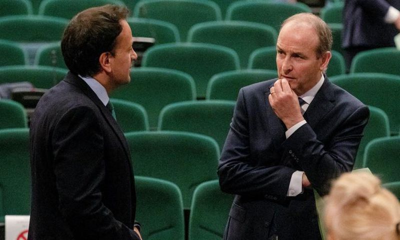 Fianna Fail leader Micheal Martin (R) talks with the man who he has replaced as Irish prime minister, Leo Varadkar after the vote at a special sitting of the Dail parliament