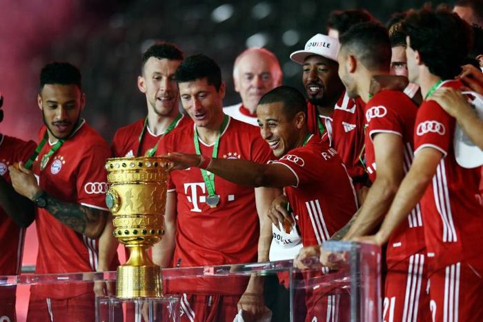 Thiago Alcantara touches the German Cup trophy after Bayern Munich's 4-2 triump over Bayer Levekursen in Saturday's German Cup final.